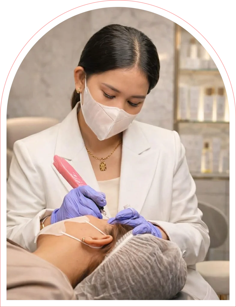 Divine Grace Alecha, international SPMU Master Trainer, performing a precision brow procedure at her studio in Cebu, Philippines